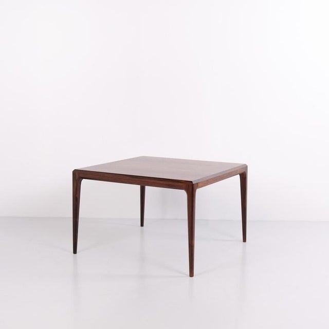Coffee table crafted from rosewood, designed by johannes andersen and manufactured by cfc silkeborg in the 1960s. The...