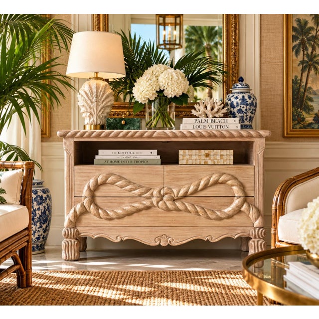 Striking 1980s vintage commode featuring an elaborate hand-carved rope and tassel motif across the drawer fronts,...