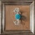 The artwork depicts a single piece of candy, wrapped in translucent paper, resting on a textured surface that enhances its...