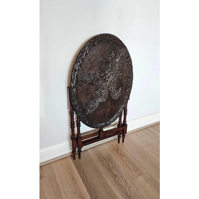 An antique English Victorian finely hand carved mahogany gate leg table by Thomas Simpson and Son. Born in England in the...