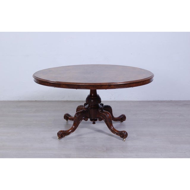 Classic Victorian-style English table. Oval, sail-shaped, with riser on narrow side. Single center leg with support on...