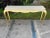 A vintage console with a pI t gilded base and a tessellated horn top.