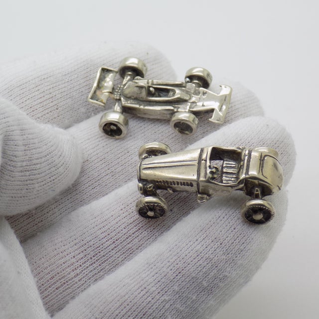 A vintage set composed of two miniature racing cars, handcrafted in Continental Silver (800/000) in Italy between the...