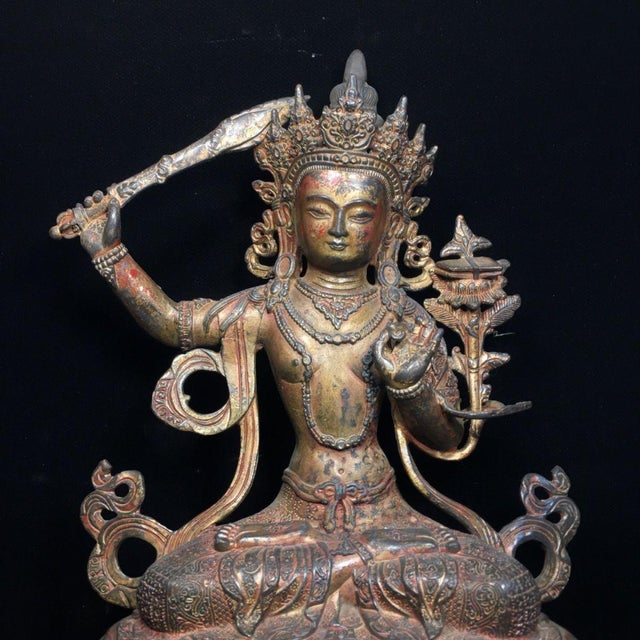 Beautiful solid bronze Manjushri Bodhisattva statue, the Bodhisattva of wisdom, seated in lotus position upon an ornate...