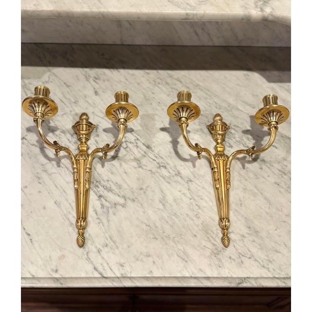 A pair of Antique French Neo-Classical Style Sconces Circa early 20th century French Louis XVI-Style Brass two-arm wall...