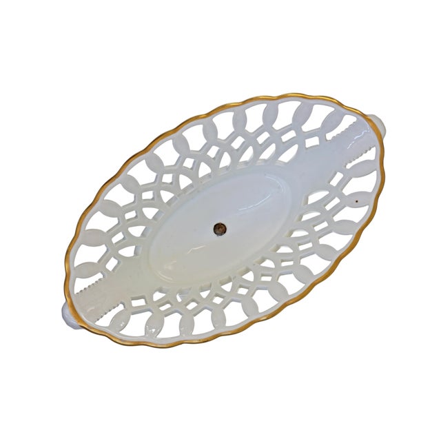 This elegant, reticulated porcelain compote, or corbeille, by Vista Alegre features an oval basket form with pointed ends...