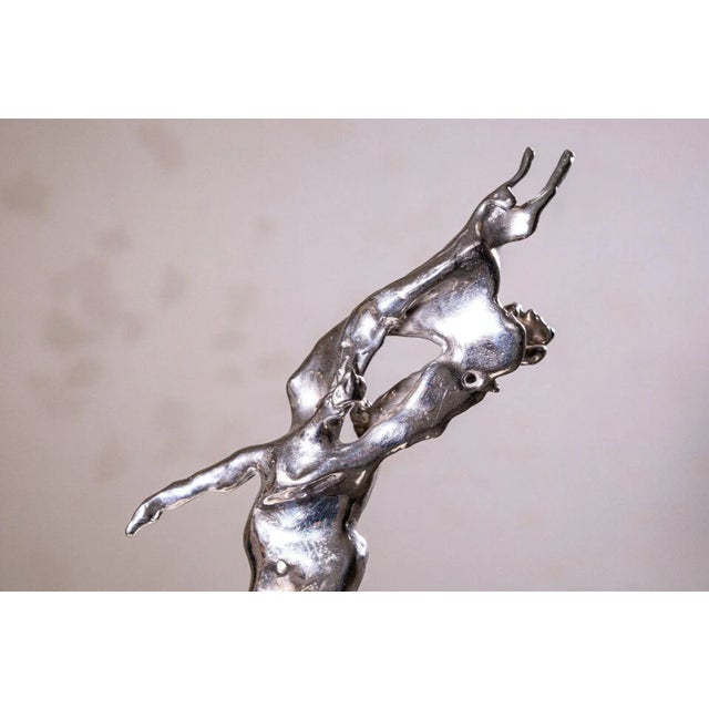 This dynamic and abstract sculpture by Don Snyder, crafted in 1974, is made from galvanized steel. The piece features...