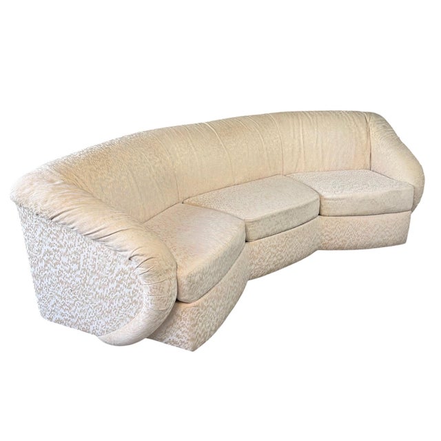 This striking pair of Mid-Century Modern sofas showcases a bold architectural silhouette defined by their gracefully...