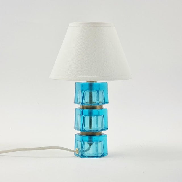 Stunning pair of glass & brass bedside/table lamps by carl fagerlund for orrefors (sweden, 1960s). Three thick blue glass...