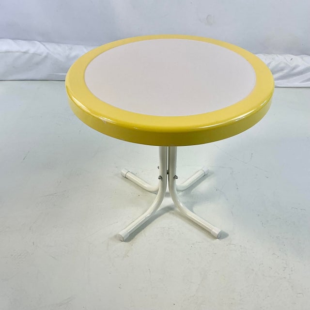 This is a wonderful find. A metal outdoor round side table in cheery Canary Yellow and White. It’s a great addition to any...