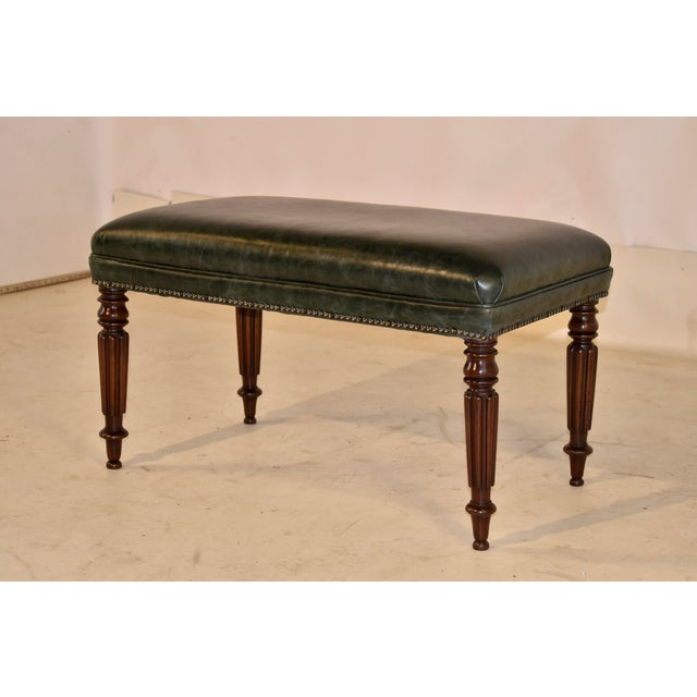 19th century leather upholstered mahogany bench from England. The top has been expertly upholstered in a rich green...