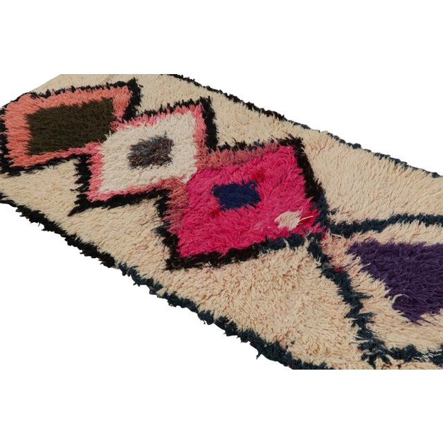 Hand-knotted in wool circa 1950-1960, this vintage 3x7 Moroccan runner is believed to hail from the Azilal tribe. On the...