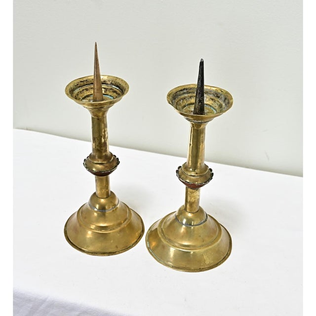 Dimensions: 14” H x 5 ¾” W x 5 ¾” D A pair of Dutch, heavy brass candlesticks from the 1800s. Rather primitive in design...