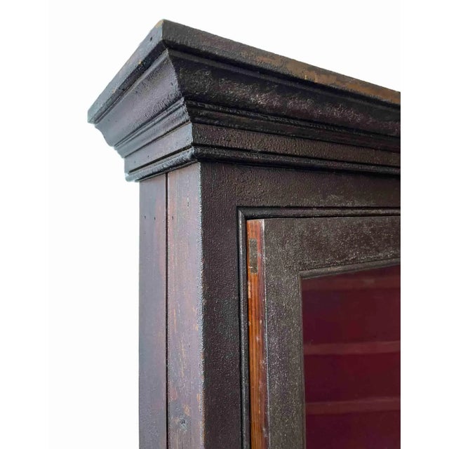 Antique wooden showcase with original wavy glass door. Varnish surface is distressed and could use surface restoration....
