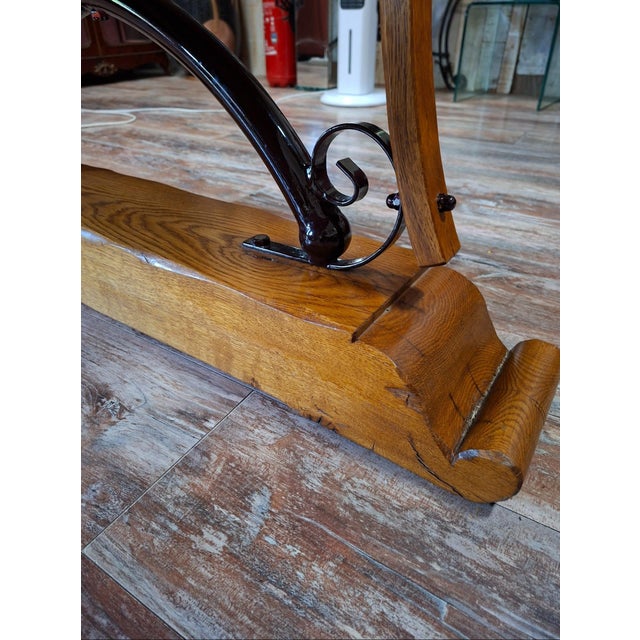 Large polished granite dining table on an oak and wrought iron base This imposing dining table is exquisitely crafted,...