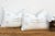 Sold as a matching pair, these handcrafted Moroccan cactus silk lumbar pillows feature a stacked bowtie-diamond medallion...