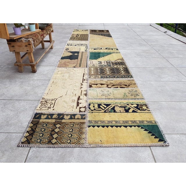 This is a vintage Turkish Oushak rug from the Mid 20th Century. The piece was hand-knotted.