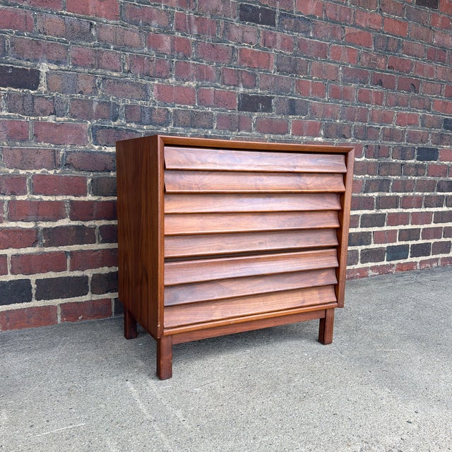A handsome Mid-Century Modern three-drawer chest from the highly sought-after Wonderwood collection by American of...