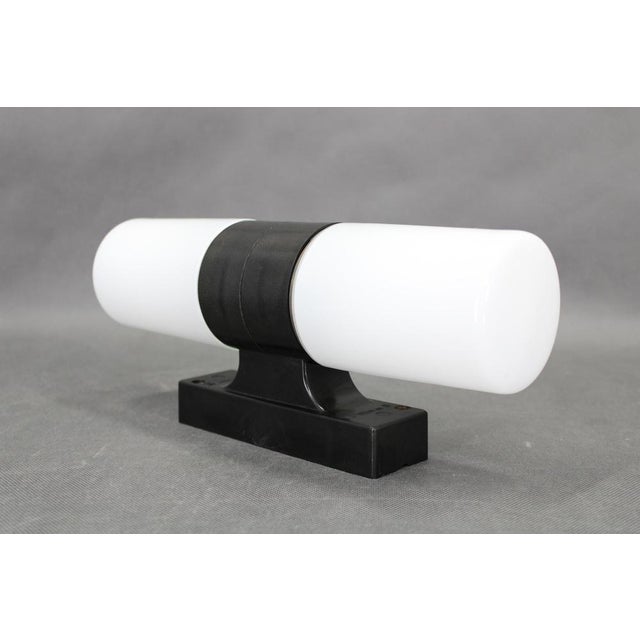 This refined mid-century wall light was produced in czechoslovakia during the 1960s. The design combines a sculptural...