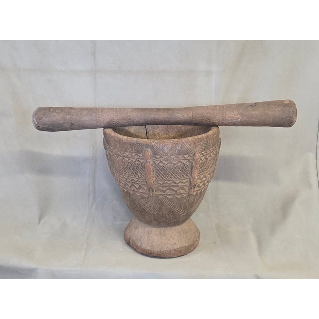 A beautifully rustic old African hand carved wood oversized mortar and pestle created by the Dogon people of Mali. It was...