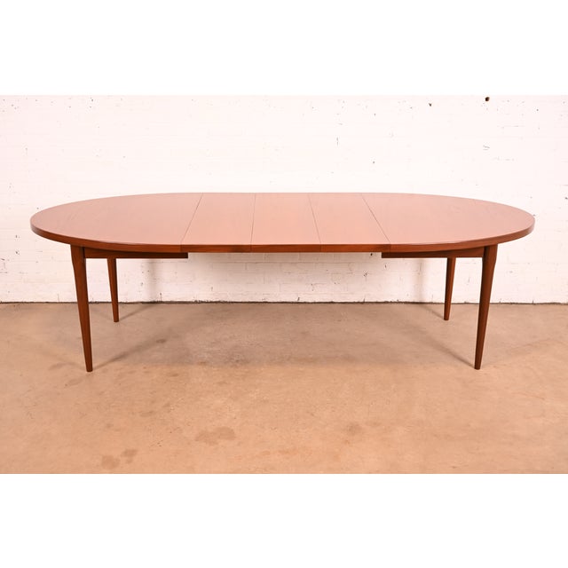 An exceptional mid-century Danish Modern extension dining table In the manner of Johannes Anderson Denmark, Circa 1960s...