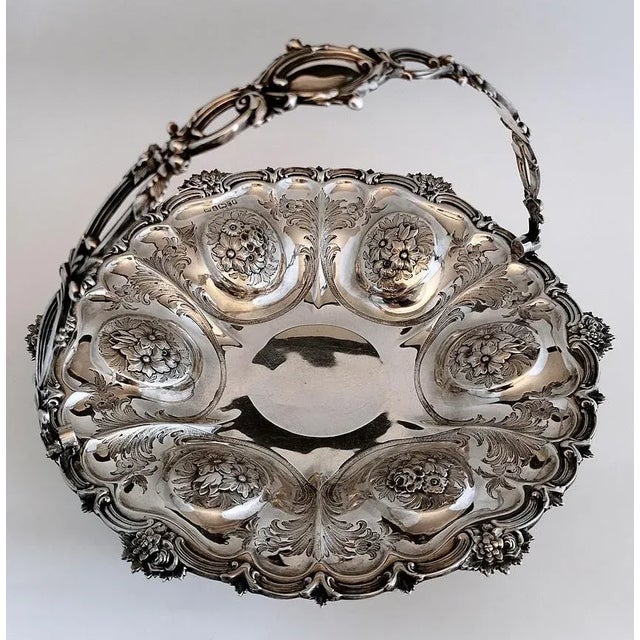 Beautiful and exceptional sterling silver basket; it has a hollowed round shape; along the entire edge is applied a floral...