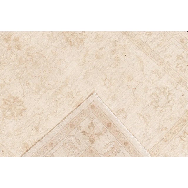 Beautiful vintage Pak Persian hand-knotted wool rug. This Persian rug has a beige field with an all-over floral medallion...