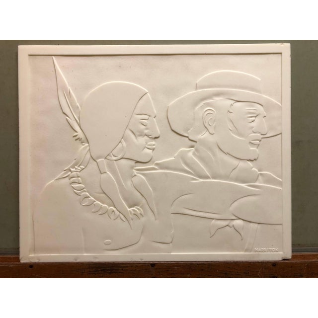 This is a carved glass panel. I belive this is milk glass. it is a classic Americana scene of a cowboy or frontier trapper...