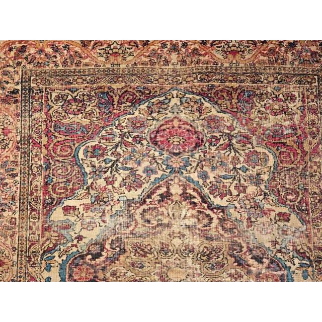 19th century Persian Kerman Lavar area rug in floral design in ivory, red, and blue colors. This beautiful Kerman Lavar...