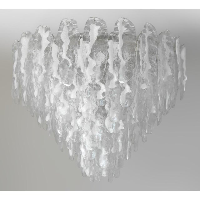 Italian chandelier shown with hand blown clear and milky white Murano glass leaves, mounted on chrome finish frame by...