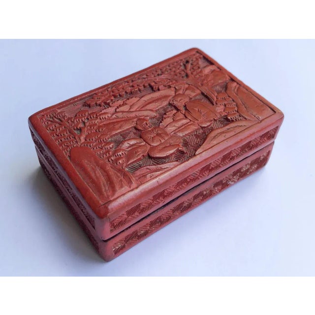 Excellent petite Chinese red with black lacquer interior Cinnabar wood box in the Chinoiserie style. Features two wise men...