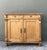 This exquisite antique European Country sideboard is a masterful display of primitive craftsmanship and Neoclassical...