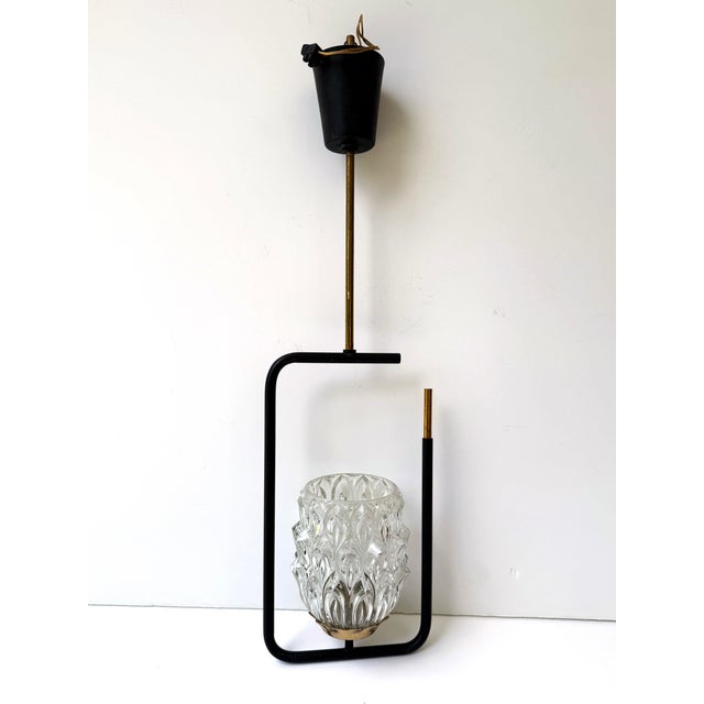 A sculptural French Mid-Century Modern pendant light produced in the 1950s and sourced in Paris. The design features a...