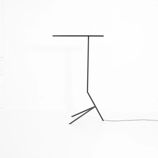 Philip Theys designed this standing light fixture in 2011. The Mantis light is made of black lacquered steel square tubes...