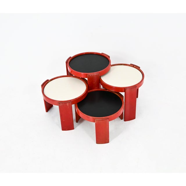 Wooden nesting table. Reversible black and white top. Stamped Cassina. Wear due to time and age of the table. Measures:...