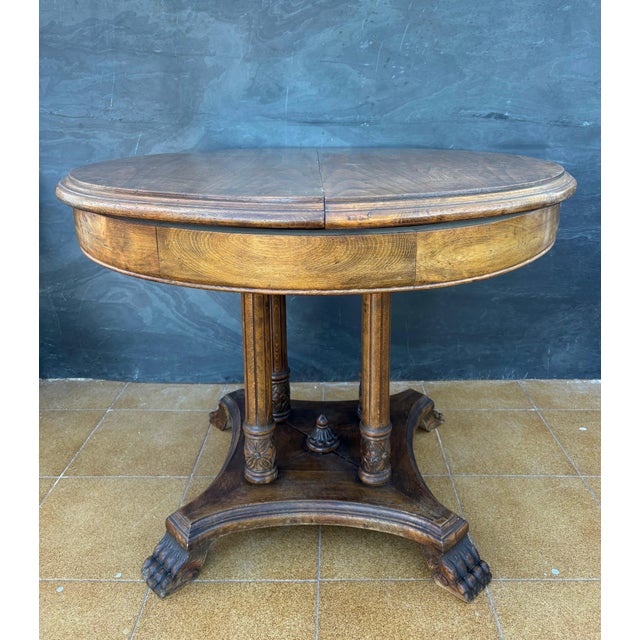 Spanish round table crafted in solid wood, dating to the early 20th century. The design reflects the historicist...
