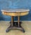 Spanish round table crafted in solid wood, dating to the early 20th century. The design reflects the historicist...