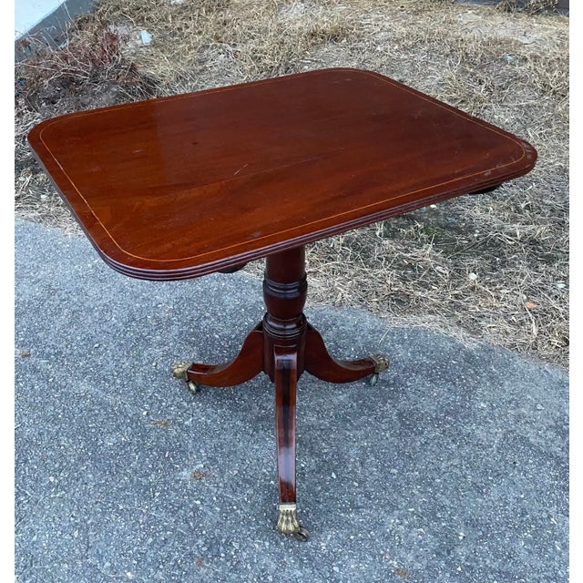 Great little 19th century English Regency tilt top mahogany side table with string inlaid top, ebony inlaid legs and paw...