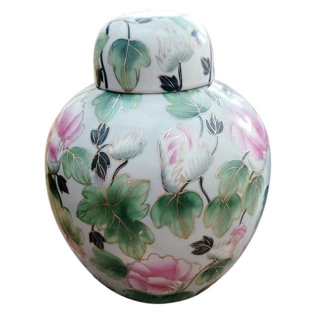 This Asian lidded ginger jar features lovely pink and white flowers with multi green leaves traced in gold on a white...