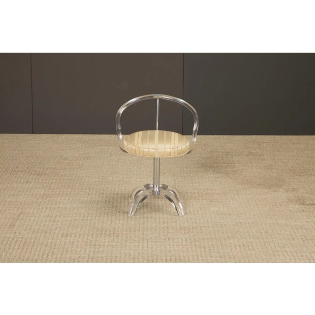 A striking 1970s Lucite vanity stool by Charles Hollis Jones, the celebrated “Mister Lucite” whose innovative designs...