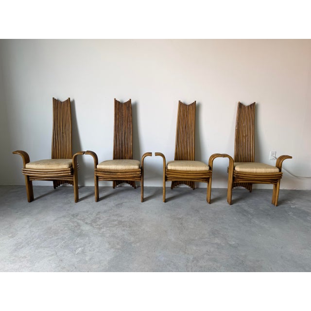 A striking set of four vintage boho chic dining chairs in the style of McGuire, featuring beautifully sculptural tall...