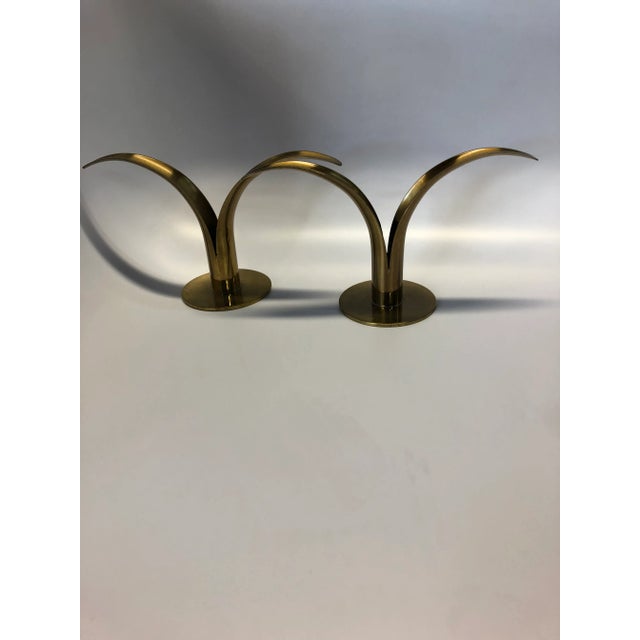 Pair of solid brass Ystad Metal candle holders. They include a lily shape.