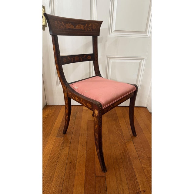 This striking armless side chair is a fine example of late 19th century Dutch craftsmanship, featuring an elegant Regency-...