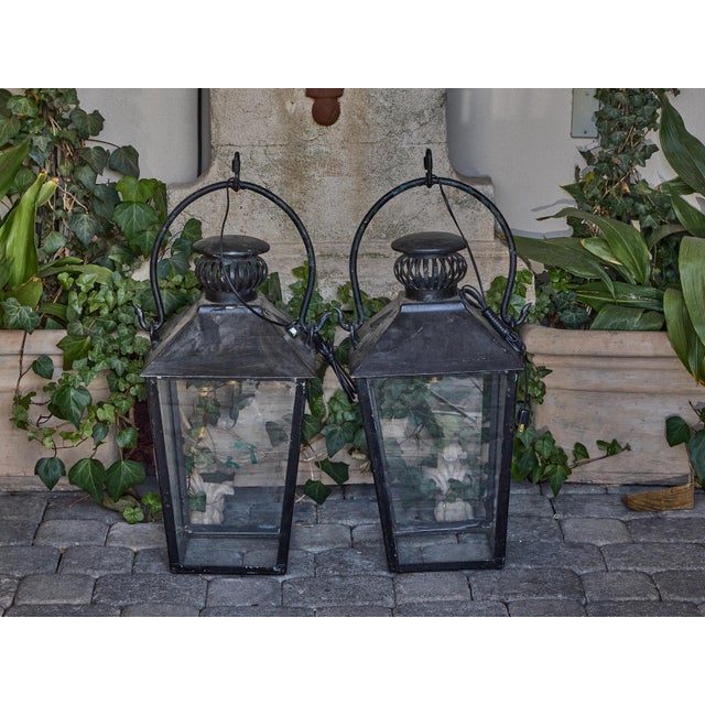 This pair of vintage iron lanterns brings classic English charm to any exterior or covered interior space. Crafted in the...