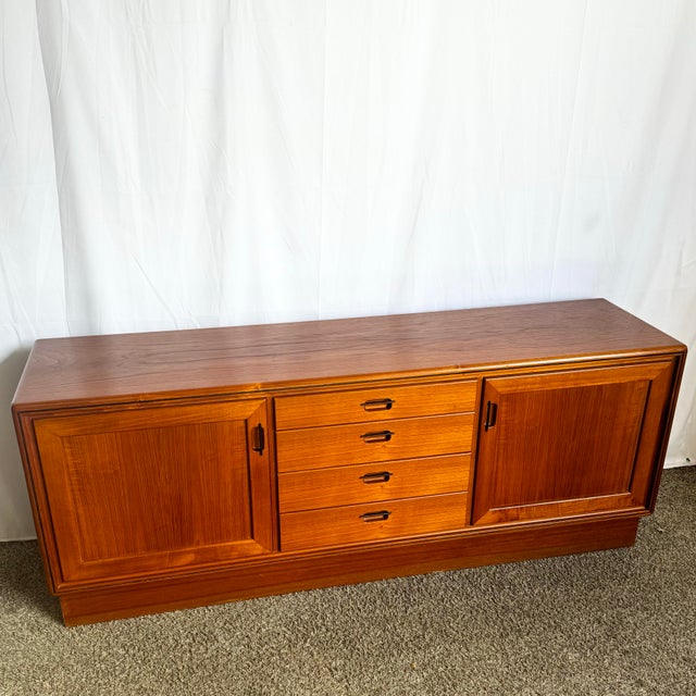 This Mid-Century Modern Teak Credenza is a timeless blend of form and function. Crafted from warm, richly grained teak, it...
