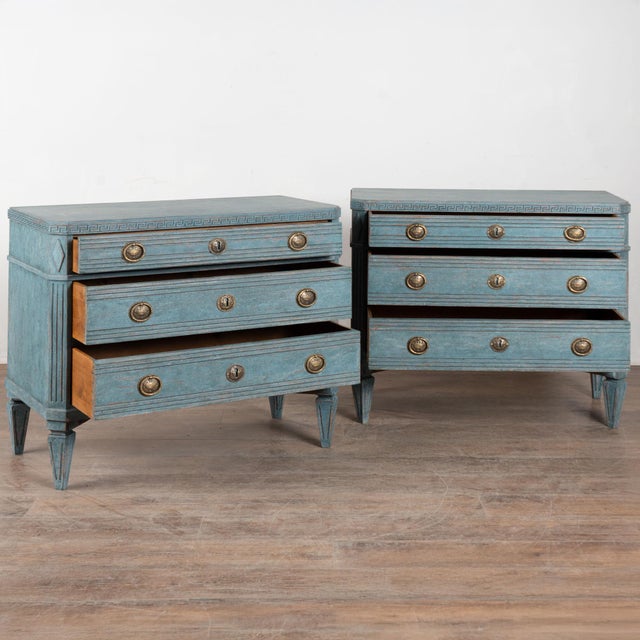 A pair of decorative Gustavian pine chest of three drawers with Greek key motif carved in upper top molding. Canted fluted...