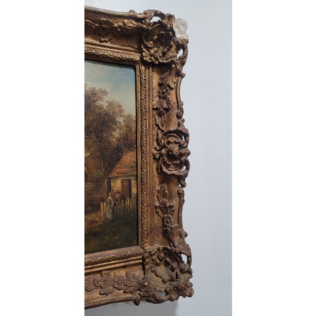 Georgina Lara British (1828-1871) This antique oil painting depicts a rural village scene with people going about their...