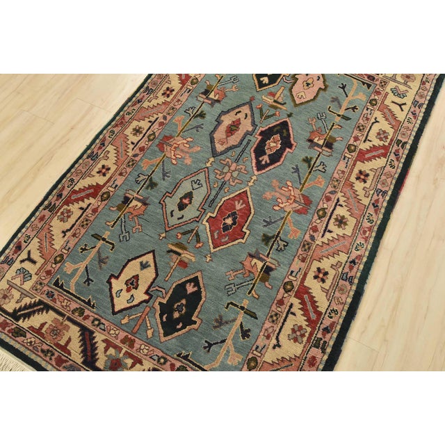 An authentic vintage tribal Heriz rug hand-knotted with fine wool on a cotton foundation. This rug features geometric...