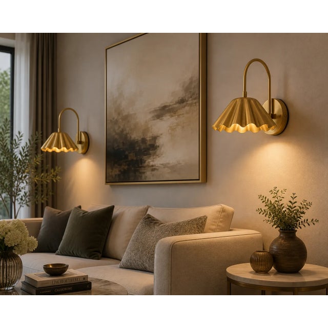 Add a warm decorative accent to your interior with this handcrafted brass scalloped wall sconce. The fixture features a...
