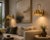 Add a warm decorative accent to your interior with this handcrafted brass scalloped wall sconce. The fixture features a...